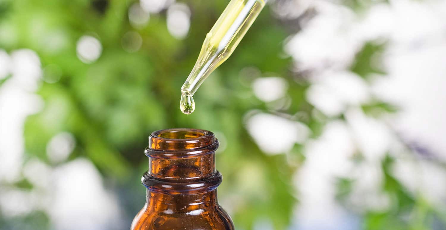 a cbd tincture dripping into a bottle